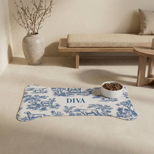 Blue toile bone-shaped personalized pet feeding mat with a bowl in a calm neutral living room