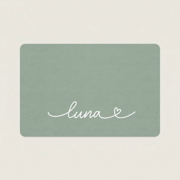 Green dog food mat with name 'luna' and a heart on a beige background