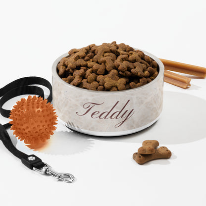 Beige marble personalized dog bowl with kibble styled with a leash, toy and cinnamon sticks