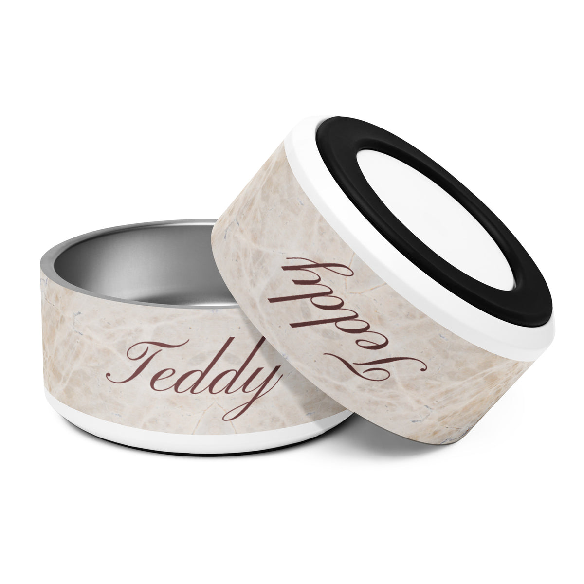 Two beige marble personalized dog bowls tilted together showing the name Teddy in calligraphy
