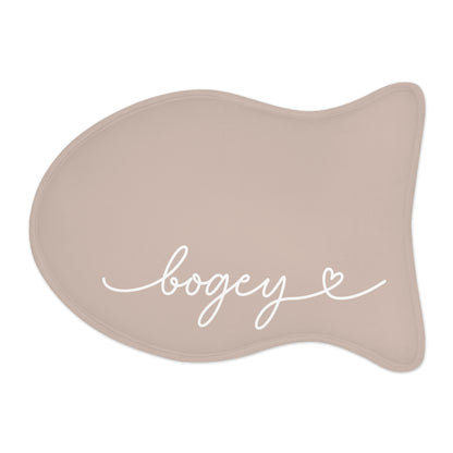 Beige fish-shaped personalized pet feeding mat with the name Bogey in white handwritten script