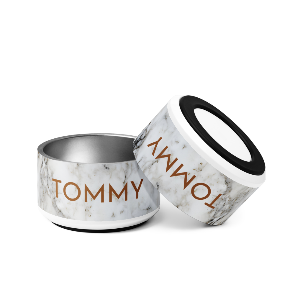 Two black and gold marble personalized dog bowls with the name Tommy, one tilted on its side
