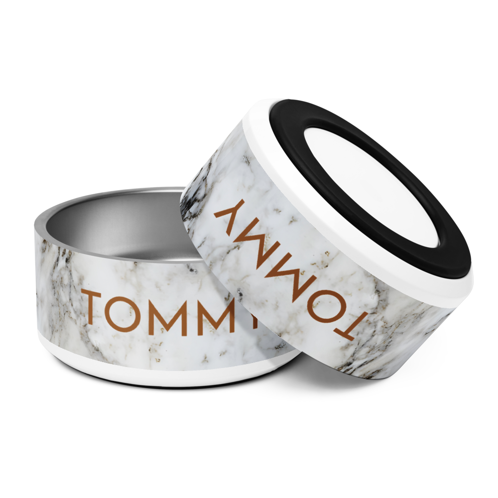 Pair of black and gold marble personalized stainless steel dog bowls with the name Tommy, tilted view