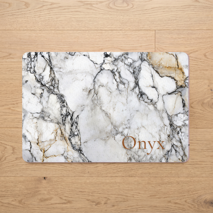 Black and gold marble personalized pet food mat with the name Onyx on a wooden floor
