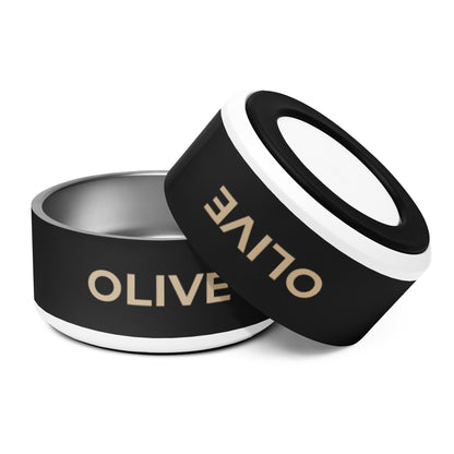 Two large black and gold modern personalized dog bowls with the name Olive, one tilted to show the rim