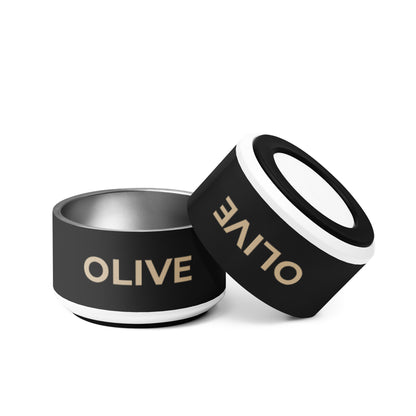 Two black and gold modern personalized dog bowls with the name Olive, one tilted to show the rim