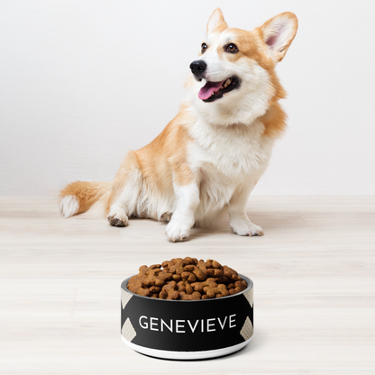 Corgi sitting next to a black biscuit personalized stainless steel dog bowl filled with kibble