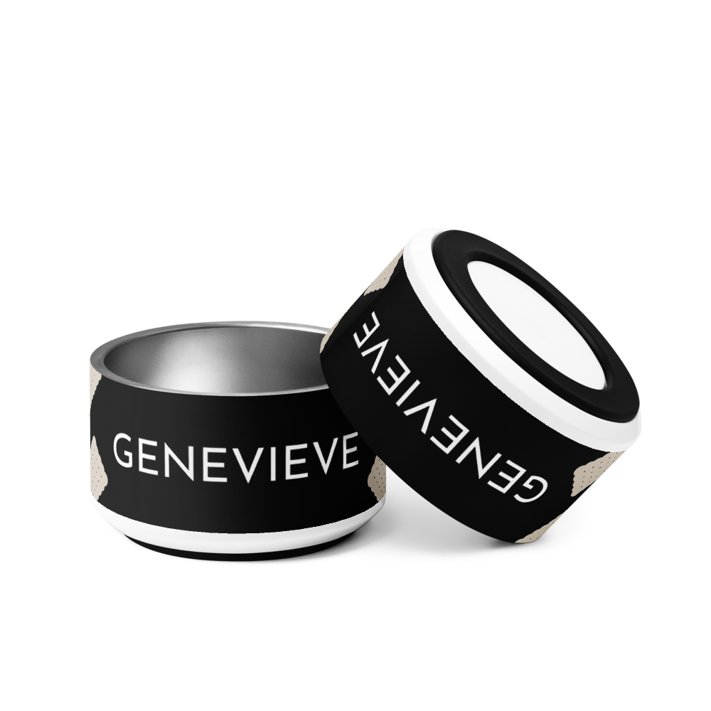 Two black biscuit personalized dog bowls with the name Genevieve, one tilted to show the rim