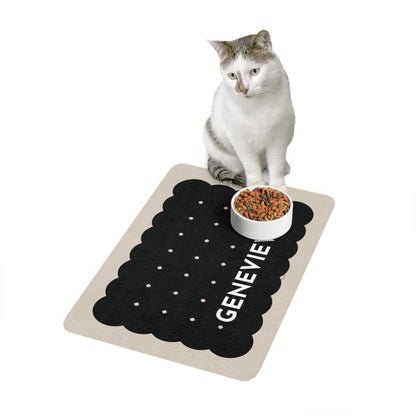 Cat sitting next to a bowl on a black biscuit personalized pet food mat
