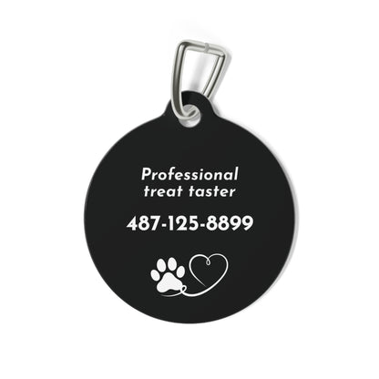 Back of black biscuit personalized dog tag with Professional treat taster, phone number and a paw and heart