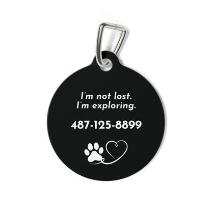 Back of black modern personalized dog tag with I'm not lost. I'm exploring., phone number and a paw and heart