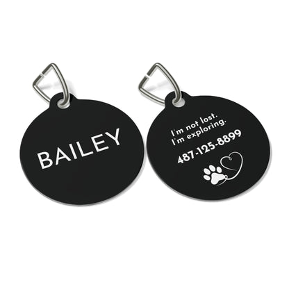 Front and back of black modern personalized dog tag with name, funny saying and phone number