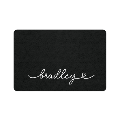 Black rectangle personalized pet food mat with the name Bradley in white handwritten script and a small heart