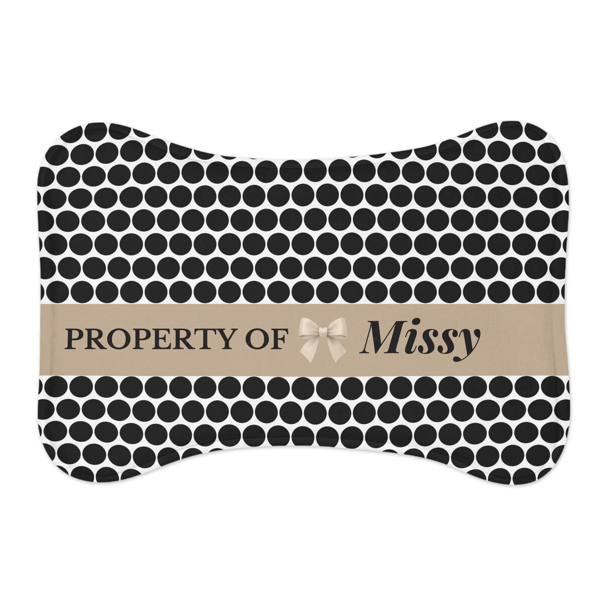 Black and white polka dot bone-shaped personalized pet feeding mat with a Property of Missy name band