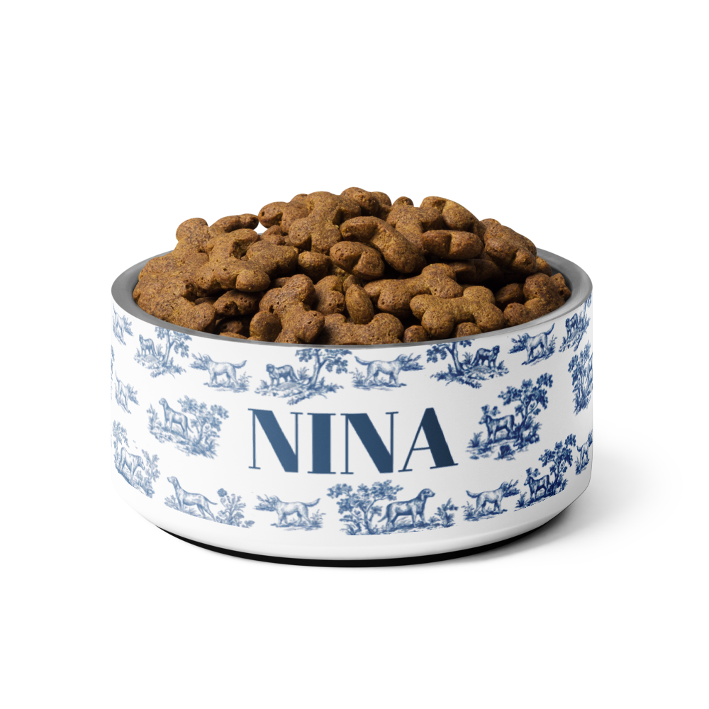 Blue toile personalized dog bowl with the name Nina filled to the brim with kibble