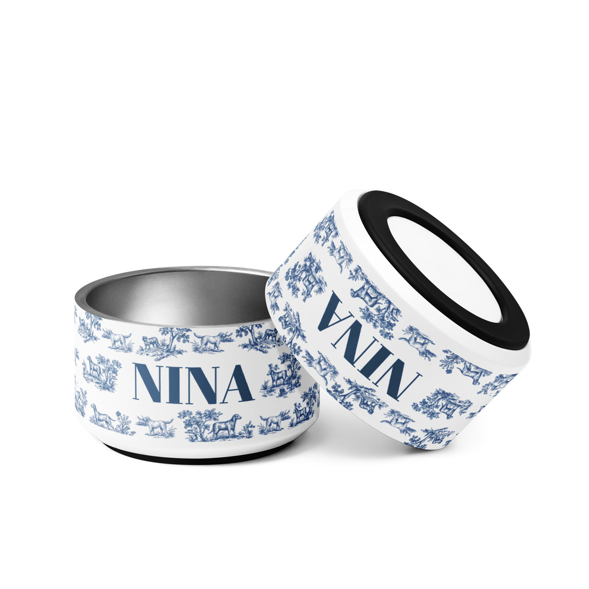 Two blue toile personalized dog bowls tilted together showing the name Nina and the non-slip base
