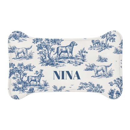 Small blue toile bone-shaped personalized pet feeding mat with the name Nina