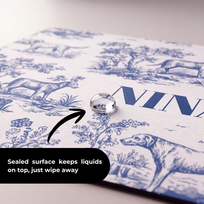 Close-up of the blue toile print and name on the personalized pet food mat