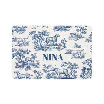 Blue toile personalized pet food mat with dogs in a classic toile landscape and the name Nina