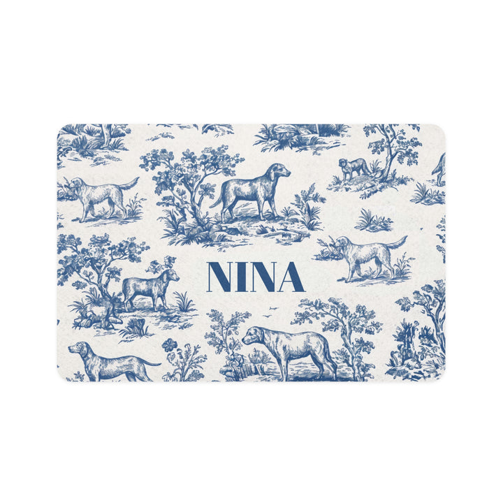 Blue toile personalized pet food mat with dogs in a classic toile landscape and the name Nina