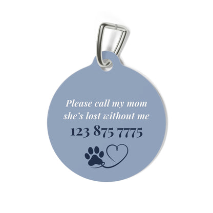 Back of the blue pet tag with printed contact message, a paw print and a heart