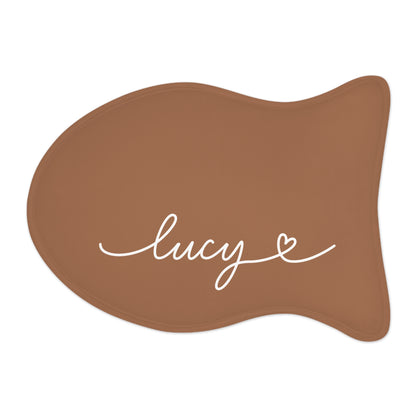 Caramel fish-shaped personalized pet feeding mat with the name Lucy in white handwritten script