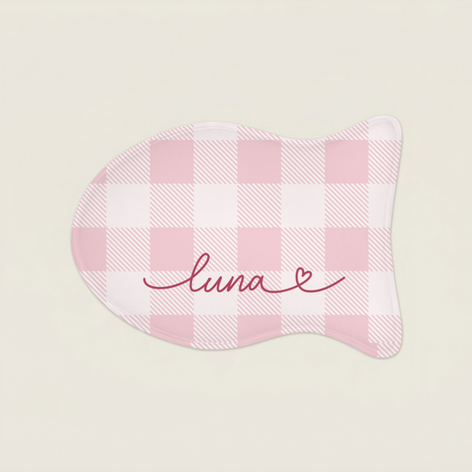 Pink cat food mat with 'luna' embroidery on a light beige background