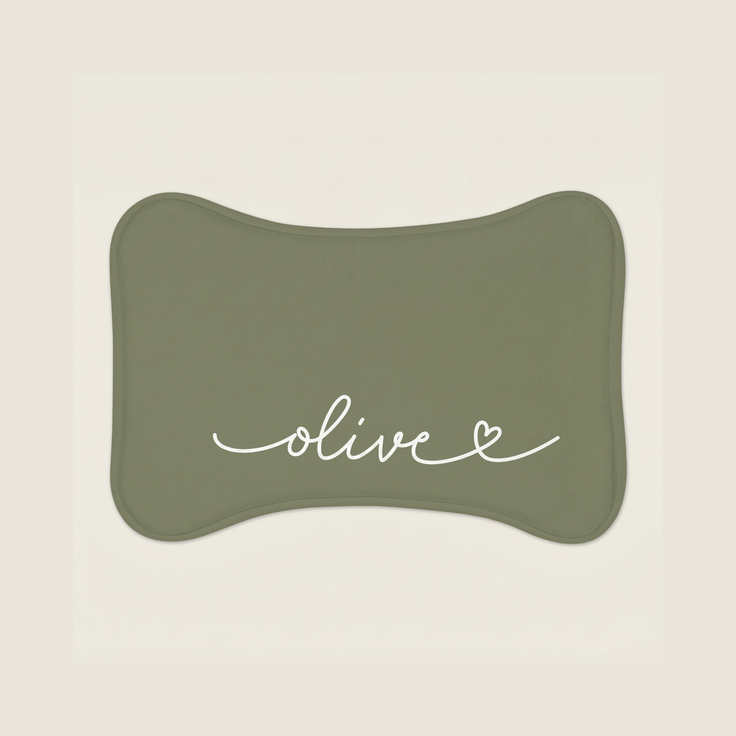 Green dog food mat with name 'olive' text on a beige background