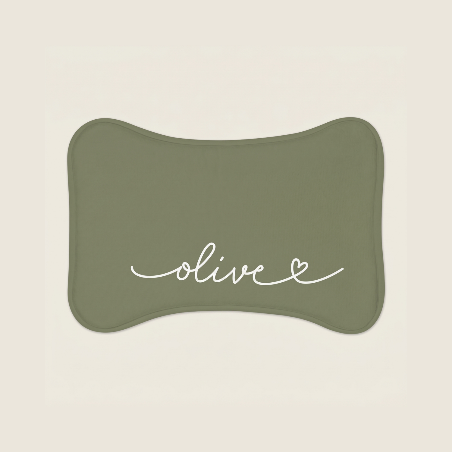 Green dog food mat with name 'olive' text on a beige background