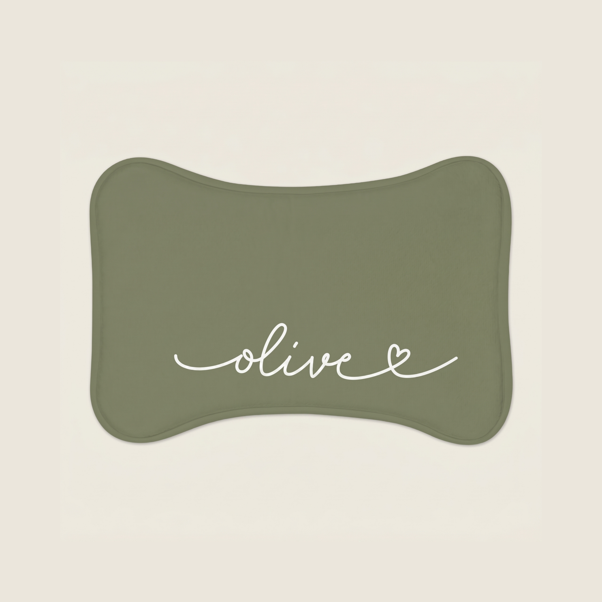 Green dog food mat with name 'olive' text on a beige background