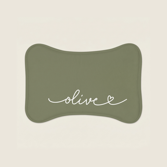 Green dog food mat with name 'olive' text on a beige background