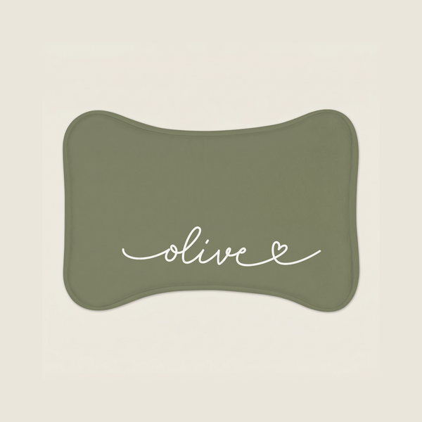 Green dog food mat with name 'olive' text on a beige background