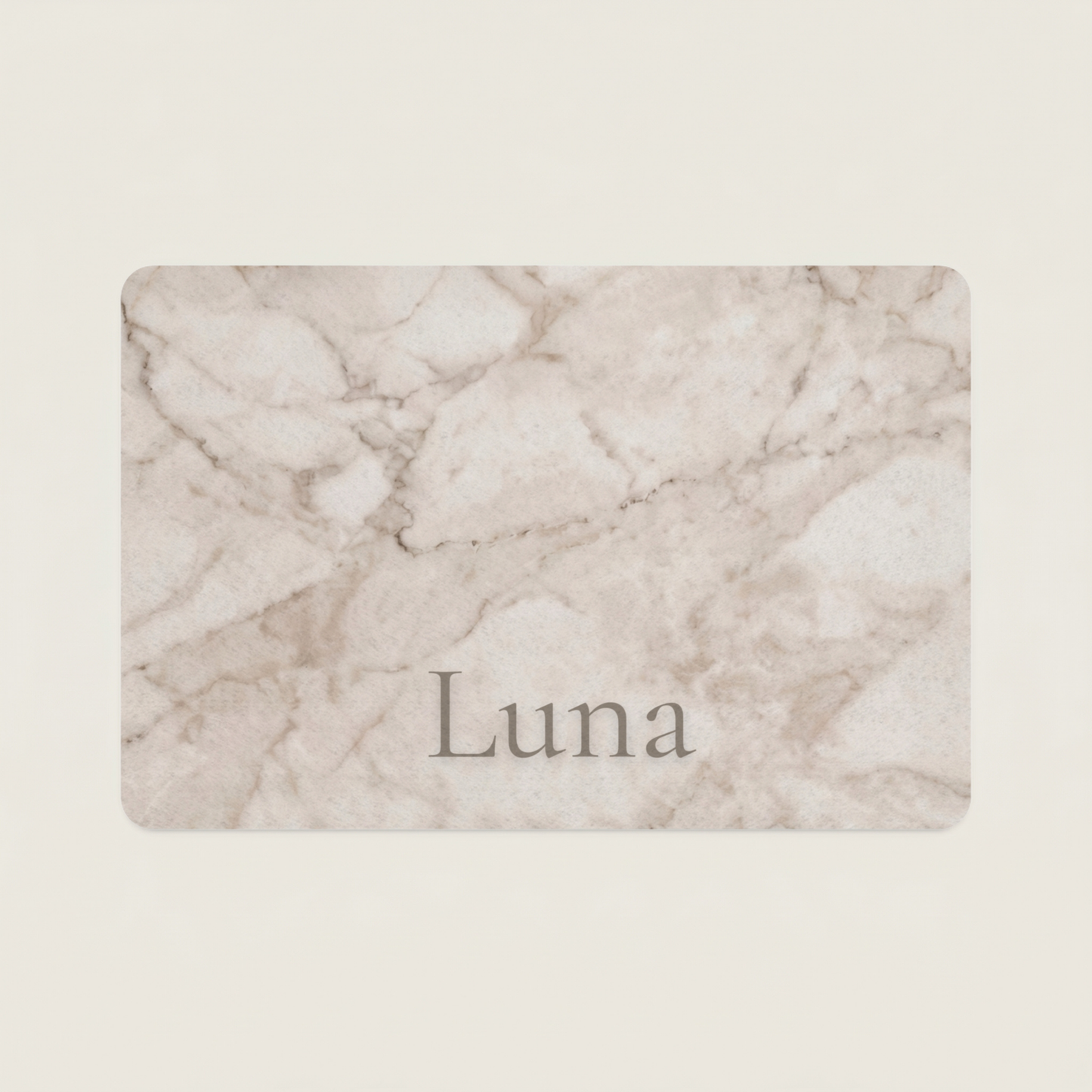 Marble-patterned dog food mat with the name 'Luna' on a beige background