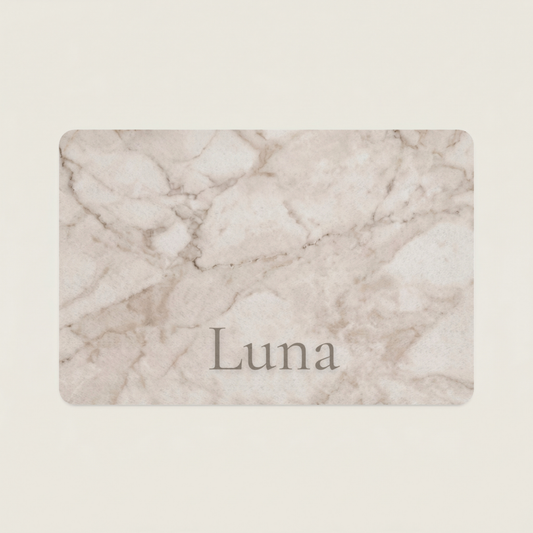 Marble-patterned dog food mat with the name 'Luna' on a beige background