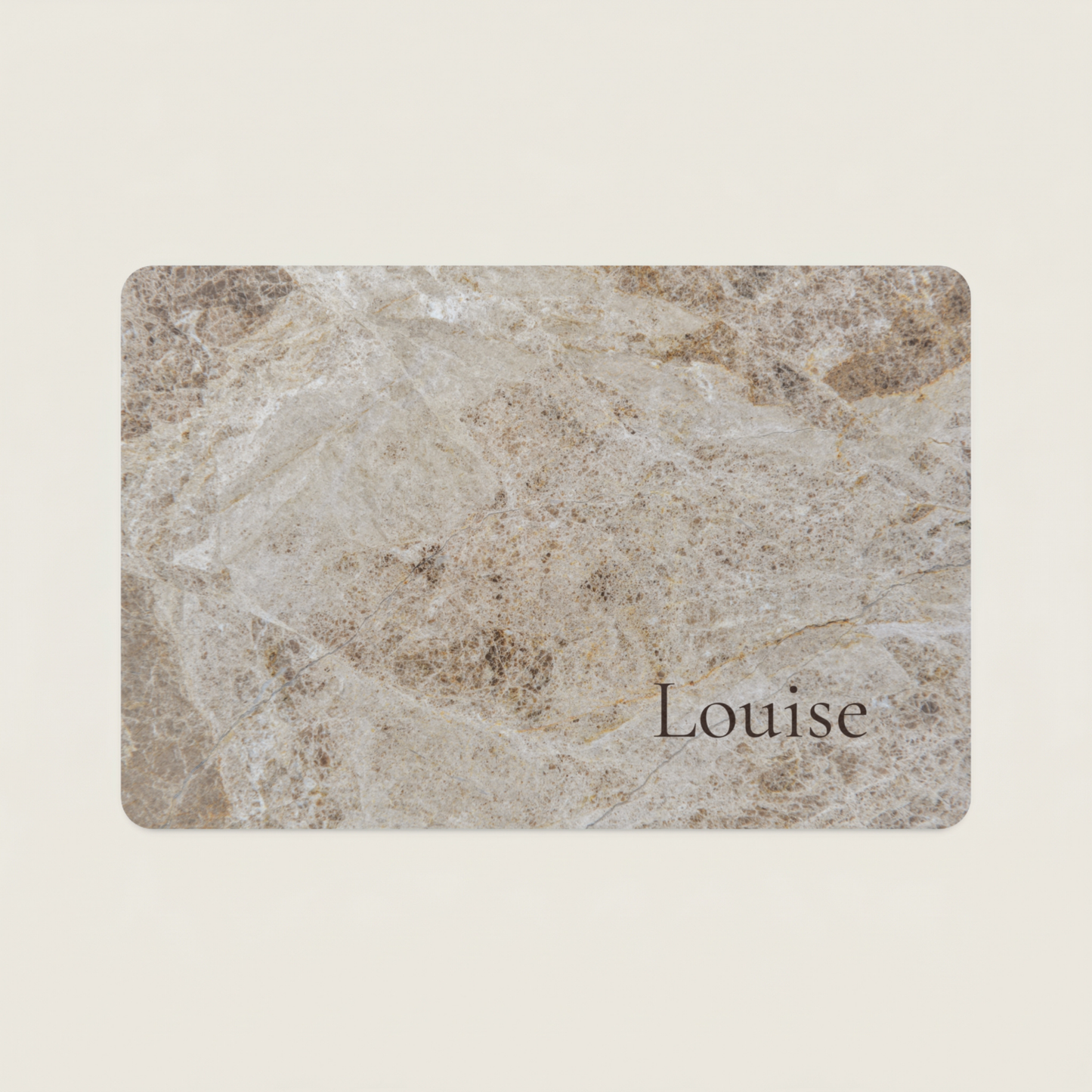 Marble-patterned dog food mat with 'Louise' printed on it against a beige background
