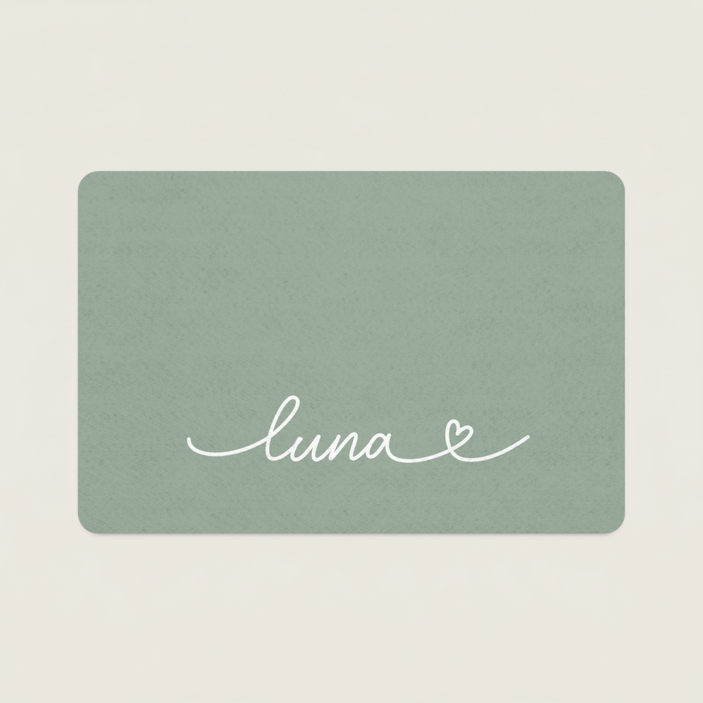Green dog food mat with name 'luna' and a heart on a beige background