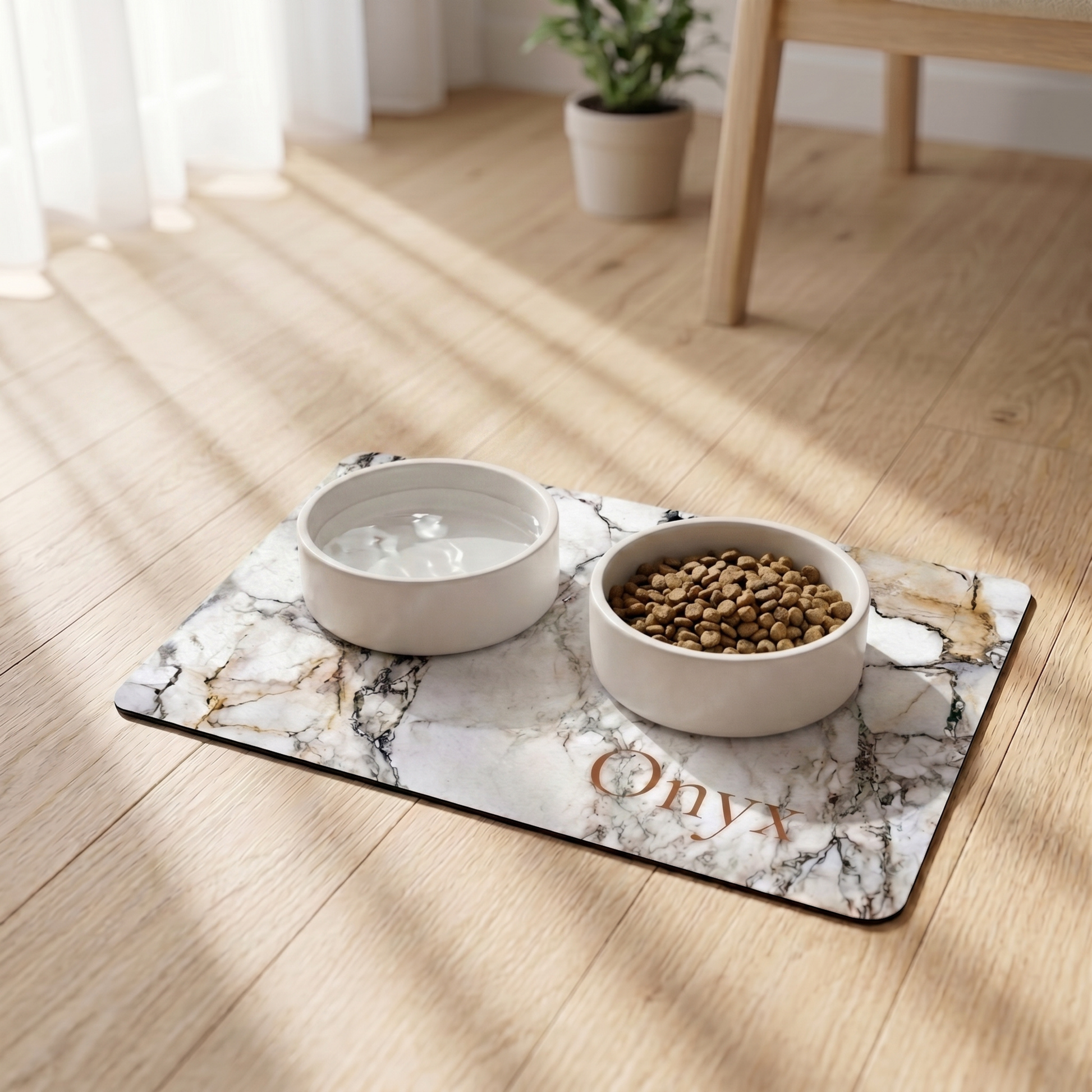 Two pet bowls with water and food on a marble-patterned dog food mat on a wooden floor.