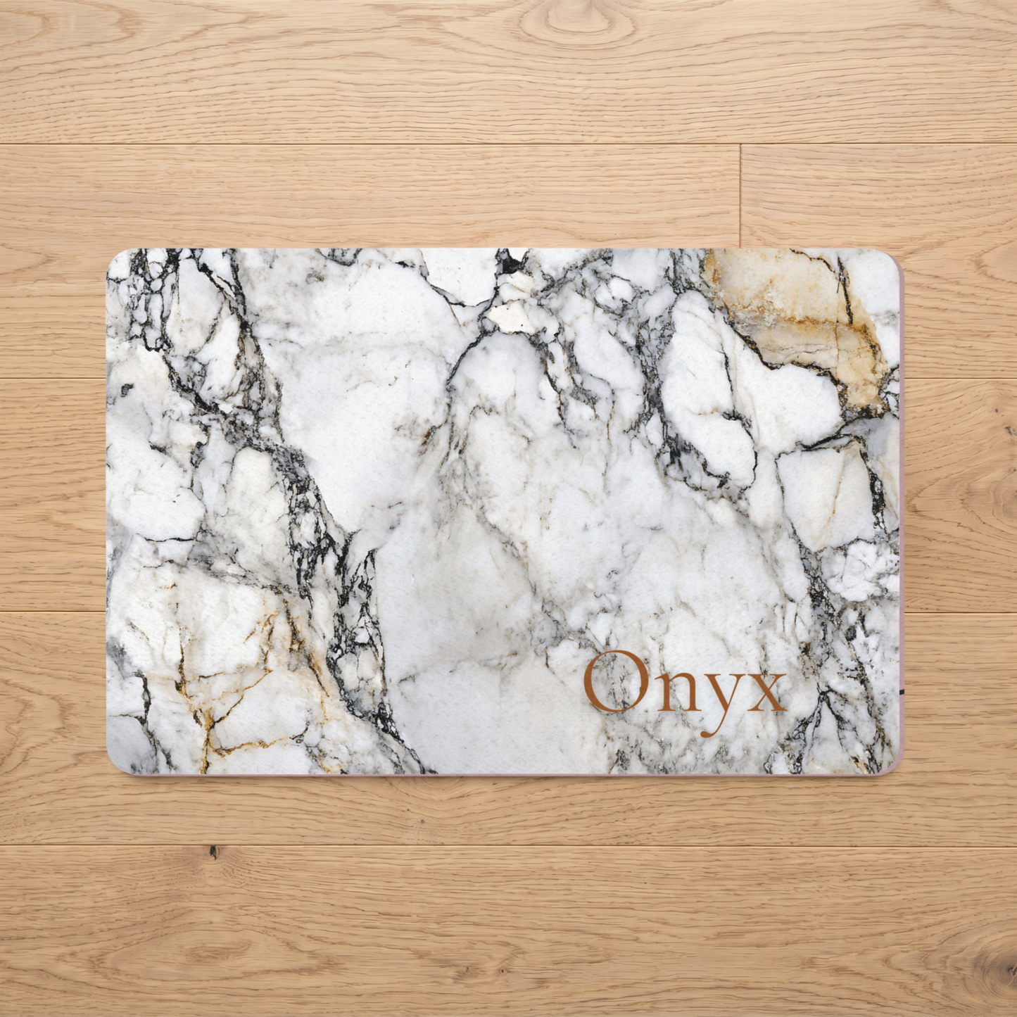 Marble-patterned dog food mat with 'Onyx' text on a wooden floor