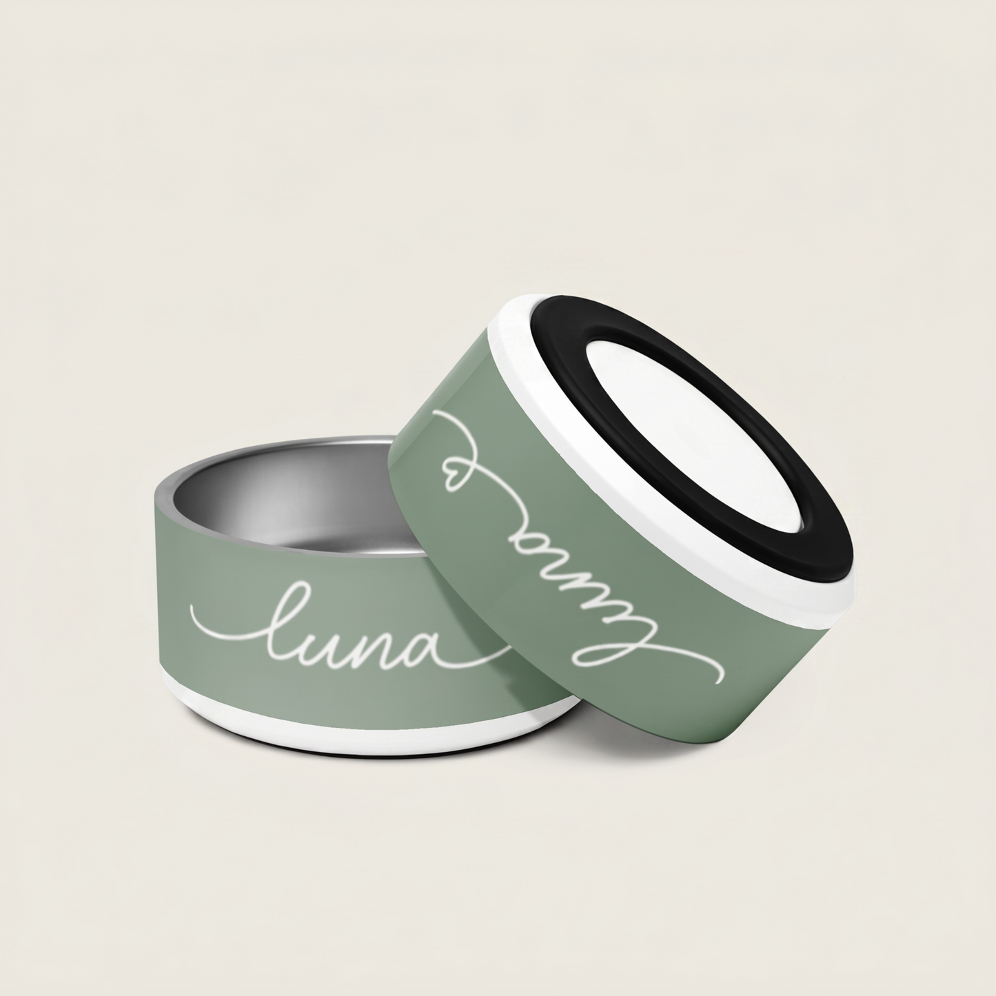 Two green pet bowls with 'luna' written on them against a beige background - Paw and Bone Atelier