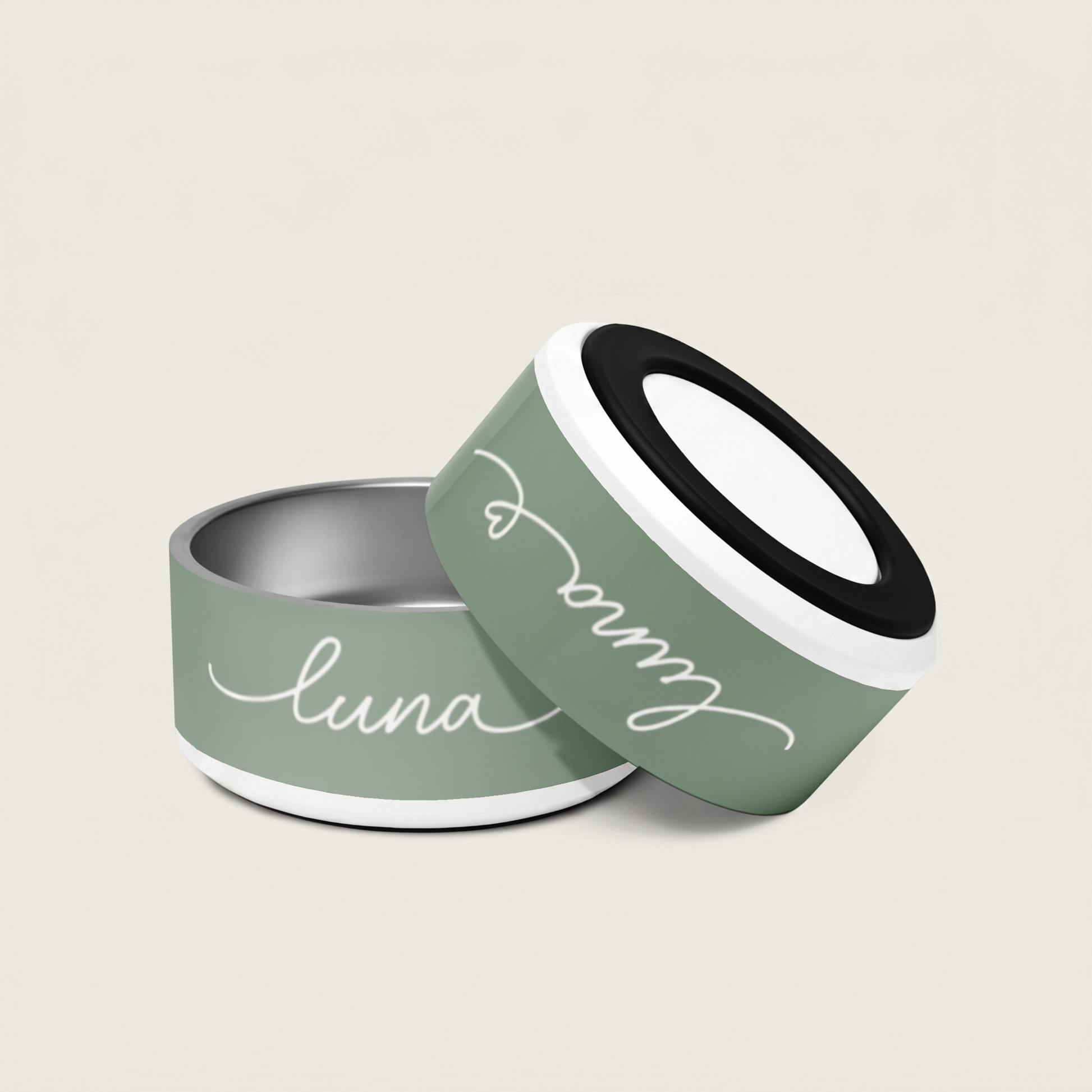 Two green pet bowls with 'luna' written on them against a beige background - Paw and Bone Atelier