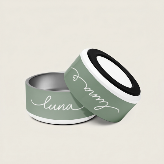 Two green pet bowls with 'luna' written on them against a beige background - Paw and Bone Atelier