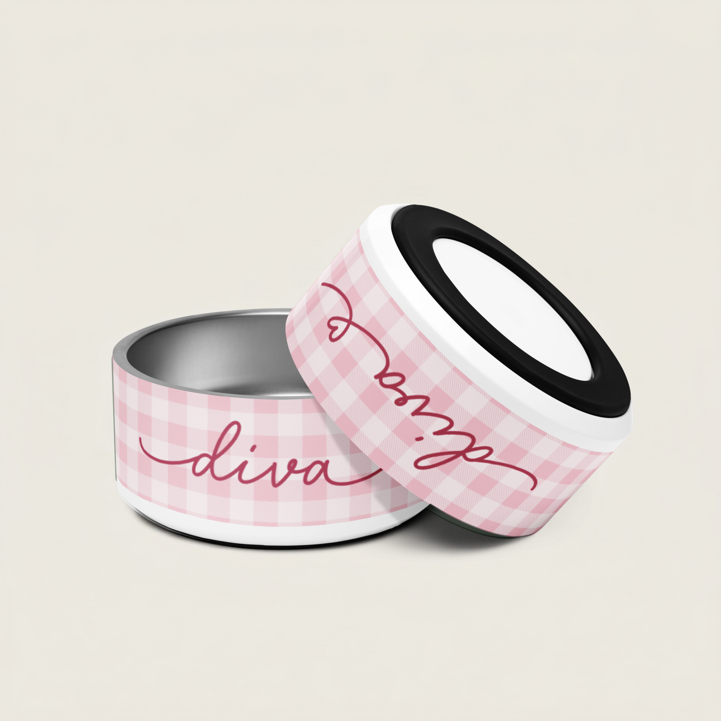 Two dog bowls with pink gingham pattern and 'diva' text on a beige background