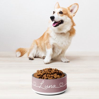 Corgi sitting next to a dusty rose personalized dog bowl filled with kibble