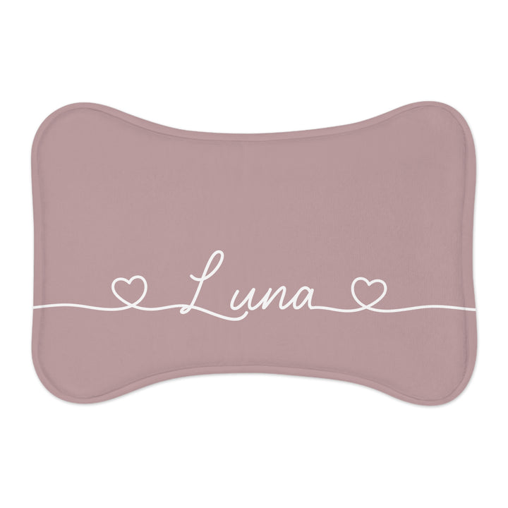 Dusty rose bone-shaped personalized pet feeding mat with the name Luna in white script between two small hearts