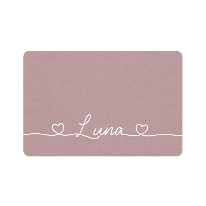 Dusty rose rectangle personalized pet food mat with the name Luna in white script between two small hearts