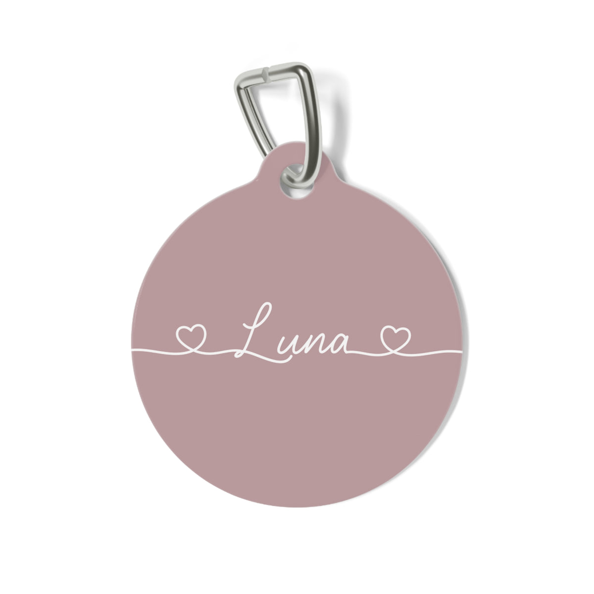 Round dusty rose personalized pet tag with the name Luna in white script between two small hearts