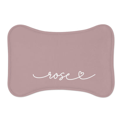 Dusty rose bone-shaped personalized pet feeding mat with the name Rose in white handwritten script and a small heart
