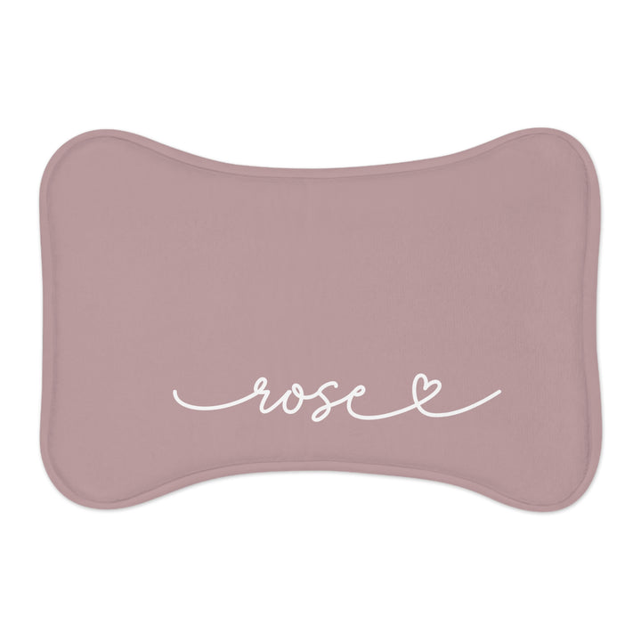 Dusty rose bone-shaped personalized pet feeding mat with the name Rose in white handwritten script and a small heart