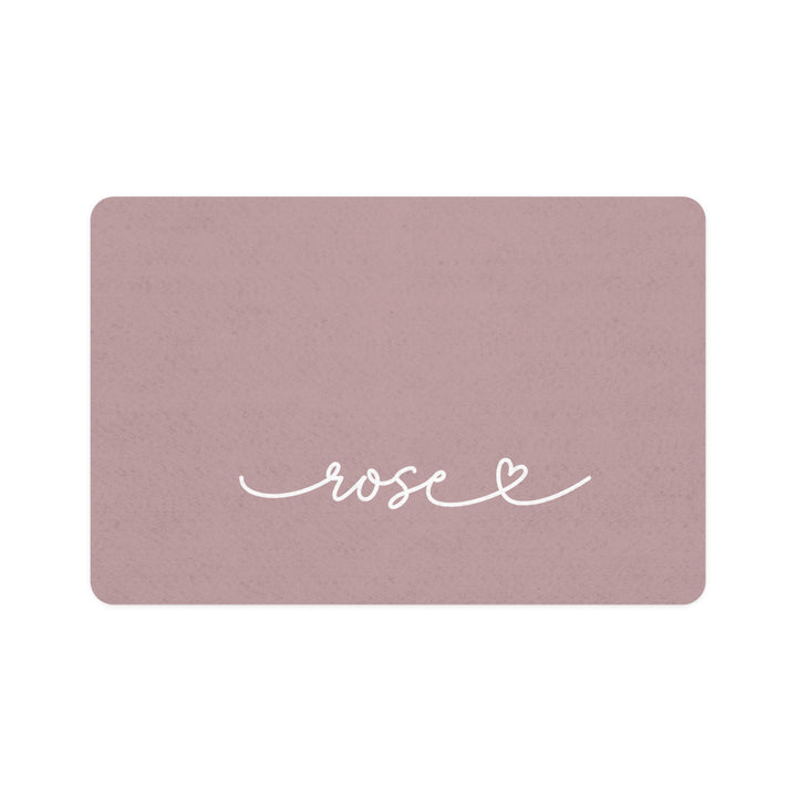 Dusty rose rectangle personalized pet food mat with the name Rose in white handwritten script and a small heart
