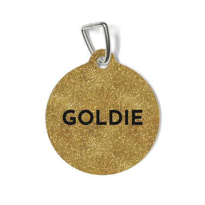 Round gold glitter personalized dog tag with the name Goldie in bold black capitals
